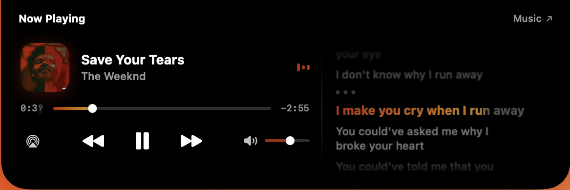 The music card with a lyrics column beside the player, the line currently being sung picked out in the artwork’s colour